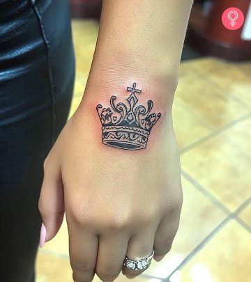 Woman designing latin tatoo on the hand