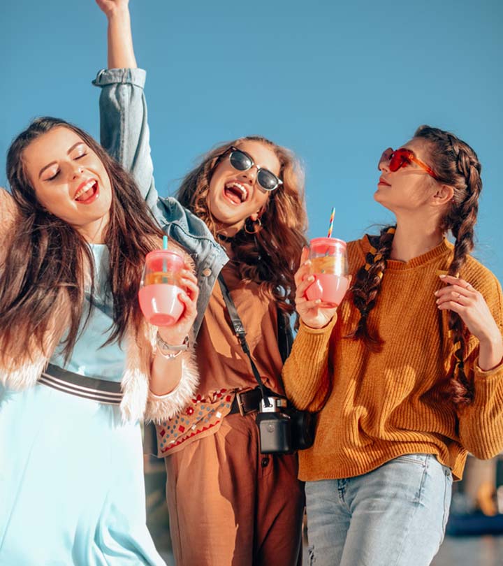 Three women in summer clothes have a lot of fun on a birthday
