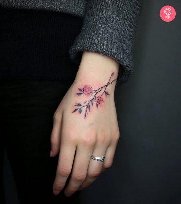 A man wearing a traditional anatomical heart tattoo on the upper arm