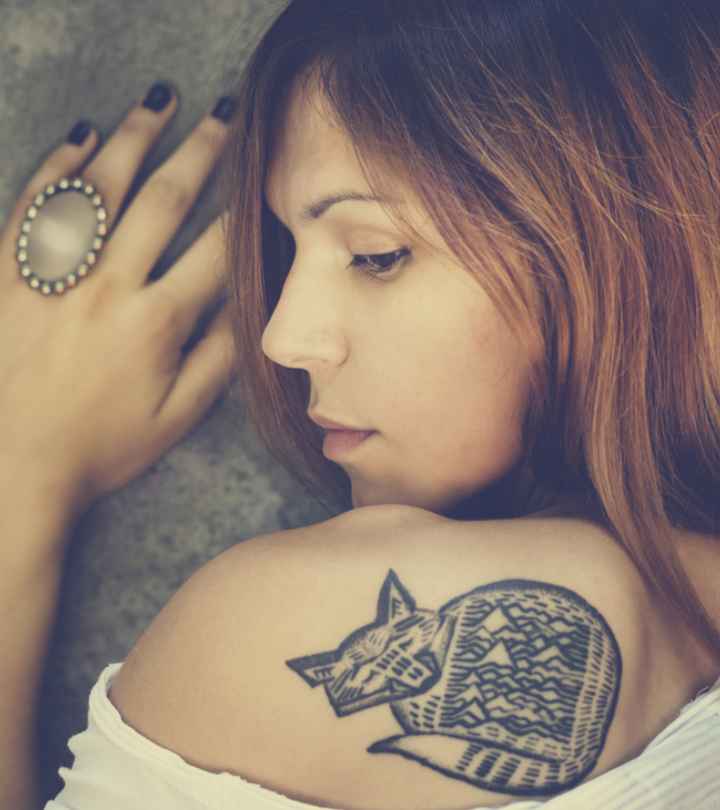 woman admiring her new tattoo