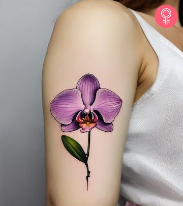 A woman with an orchid tattoo on her upper arm