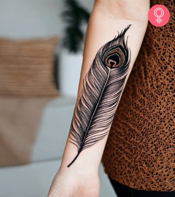 Woman with peacock feather tattoo on her forearm