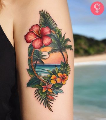 Woman with a beach tattoo on her upper arm