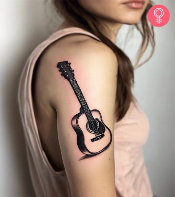 Guitar tattoo on the upper arm