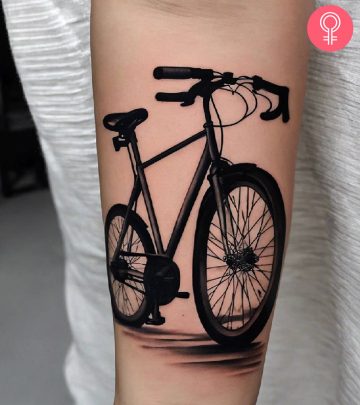 A realistic bicycle tattoo on the forearm