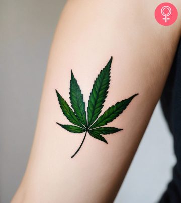 A weed tattoo design on the arm of a woman