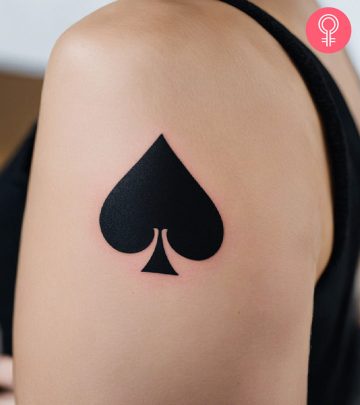 A woman with an ace of spades tattoo on her upper arm