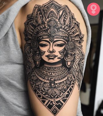 An intricate Aztec goddess tattoo on a woman’s forearm