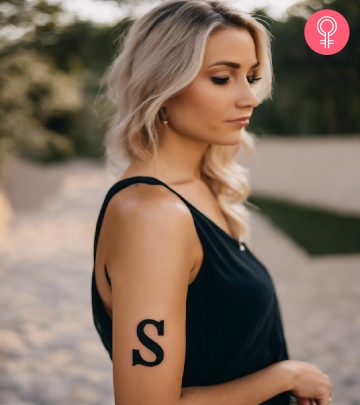 Woman with S letter tattoo on her upper arm