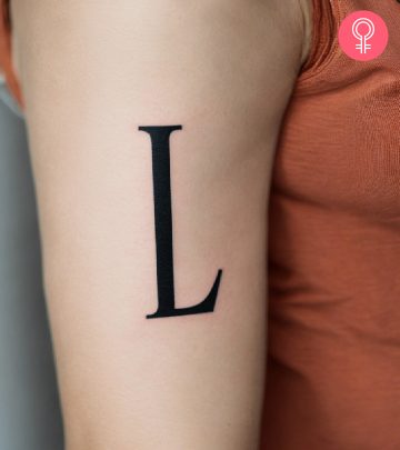 Woman with L initial tattoo on her arm