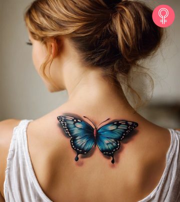 A woman with a 3D butterfly tattoo on her back
