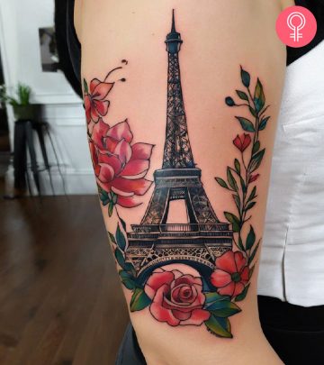 A woman with an Eiffel Tower tattoo on her upper arm