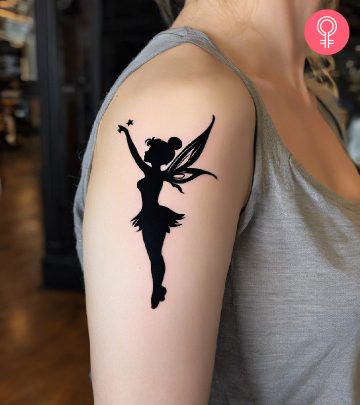 Tinkerbell tattoo on a woman’s upper arm