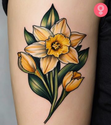 Woman with a daffodil tattoo on the arm