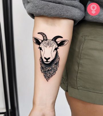 A woman with a lamb tattoo on the forearm