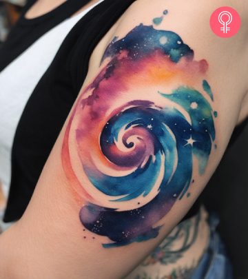 A swirl tattoo on the upper arm of a woman