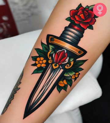 A dagger betrayal tattoo on a woman’s forearm