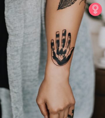 Woman with a handprint tattoo on the forearm