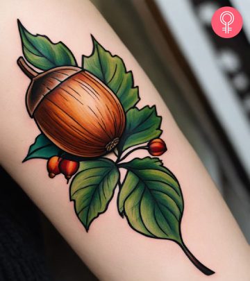 An acorn tattoo on a woman’s forearm