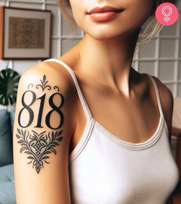 An area code tattoo on the upper arm of a woman
