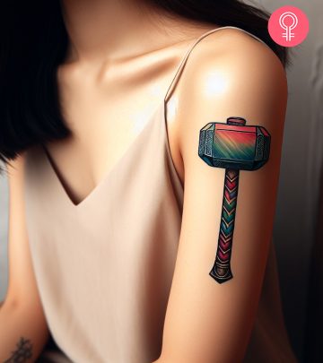 Woman with Mjolnir tattoo on her arm