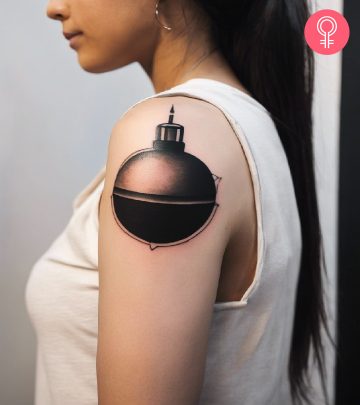 A bomb tattoo on a woman’s upper arm