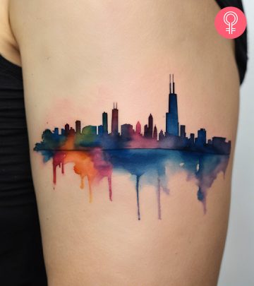 A Chicago skyline tattoo on the upper arm of a woman