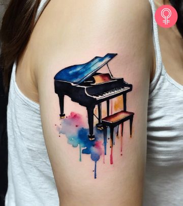 A piano tattoo on a woman’s upper arm