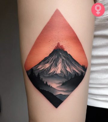 A woman wearing a minimalist volcano tattoo on the lower arm