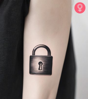 Woman with lock tattoo on her arm