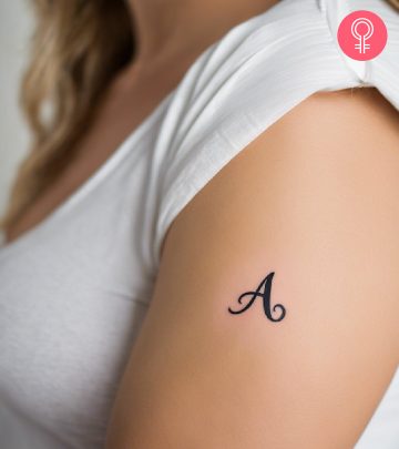 An alphabet tattoo on a woman’s upper arm