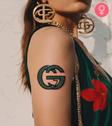 Woman with gucci symbol tattoo on her arm