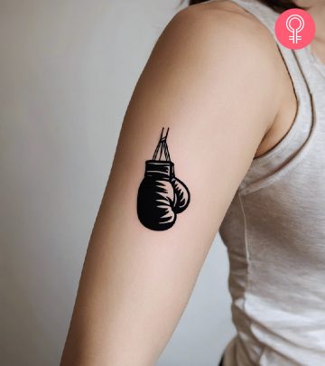 A woman with a boxing gloves tattoo on her arm