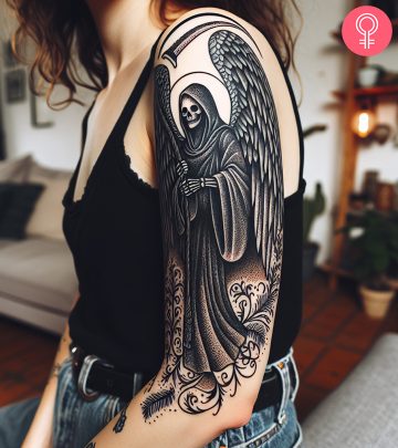 An angel of death tattoo on the upper arm