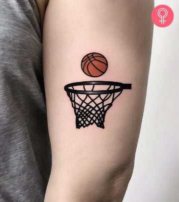 A simple basketball tattoo on a woman’s upper arm