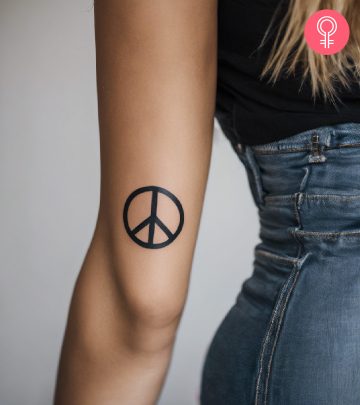 Peace sign tattoo on the arm of a woman
