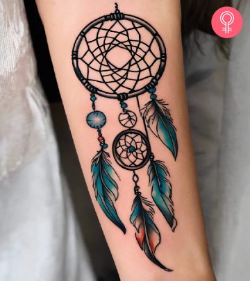 Woman with a dreamcatcher tattoo on the forearm