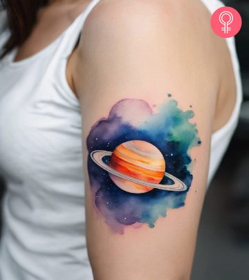 A saturn tattoo on a woman’s upper arm