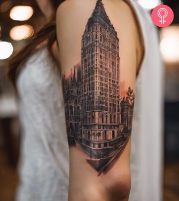 Building tattoo design on the arm of a woman