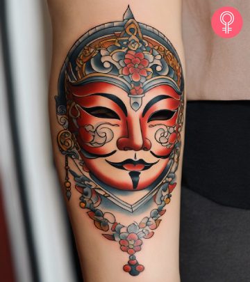 A mask tattoo on the arm