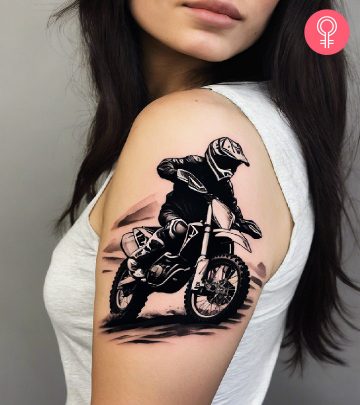 A blackwork tattoo of a motocross racer on a woman’s upper arm