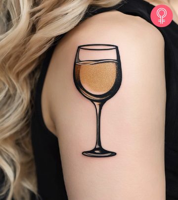 A champagne tattoo on the upper arm of a woman