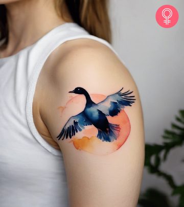 A goose tattoo on the upper arm of a woman
