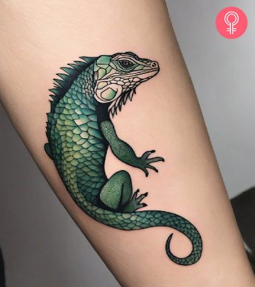 A green iguana tattoo inked on the forearm