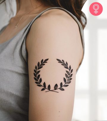 A laurel wreath tattoo on a woman’s upper arm