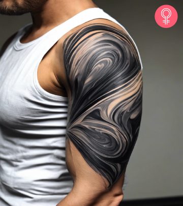 A man wearing liquid marble tattoo on the upper arm