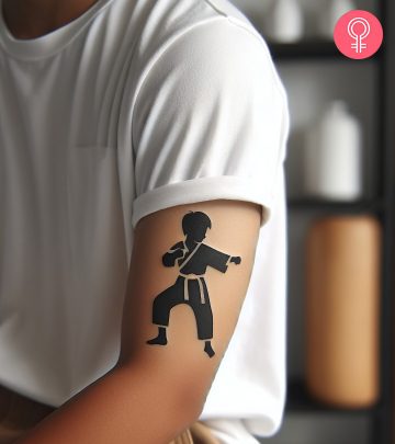 A man with a karate kid tattoo on the upper arm