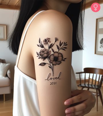 A memorial tattoo on the upper arm of a woman