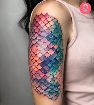 A mermaid scales tattoo on a woman’s upper arm