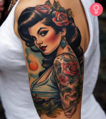 A pin-up girl tattoo on a woman’s upper arm